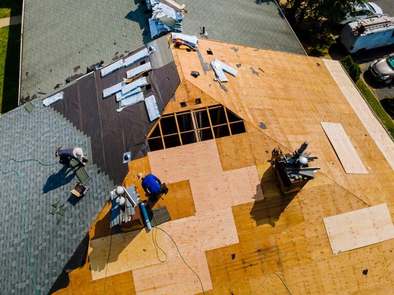 Homeowner photographs missing shingles and ceiling water stains after a storm.